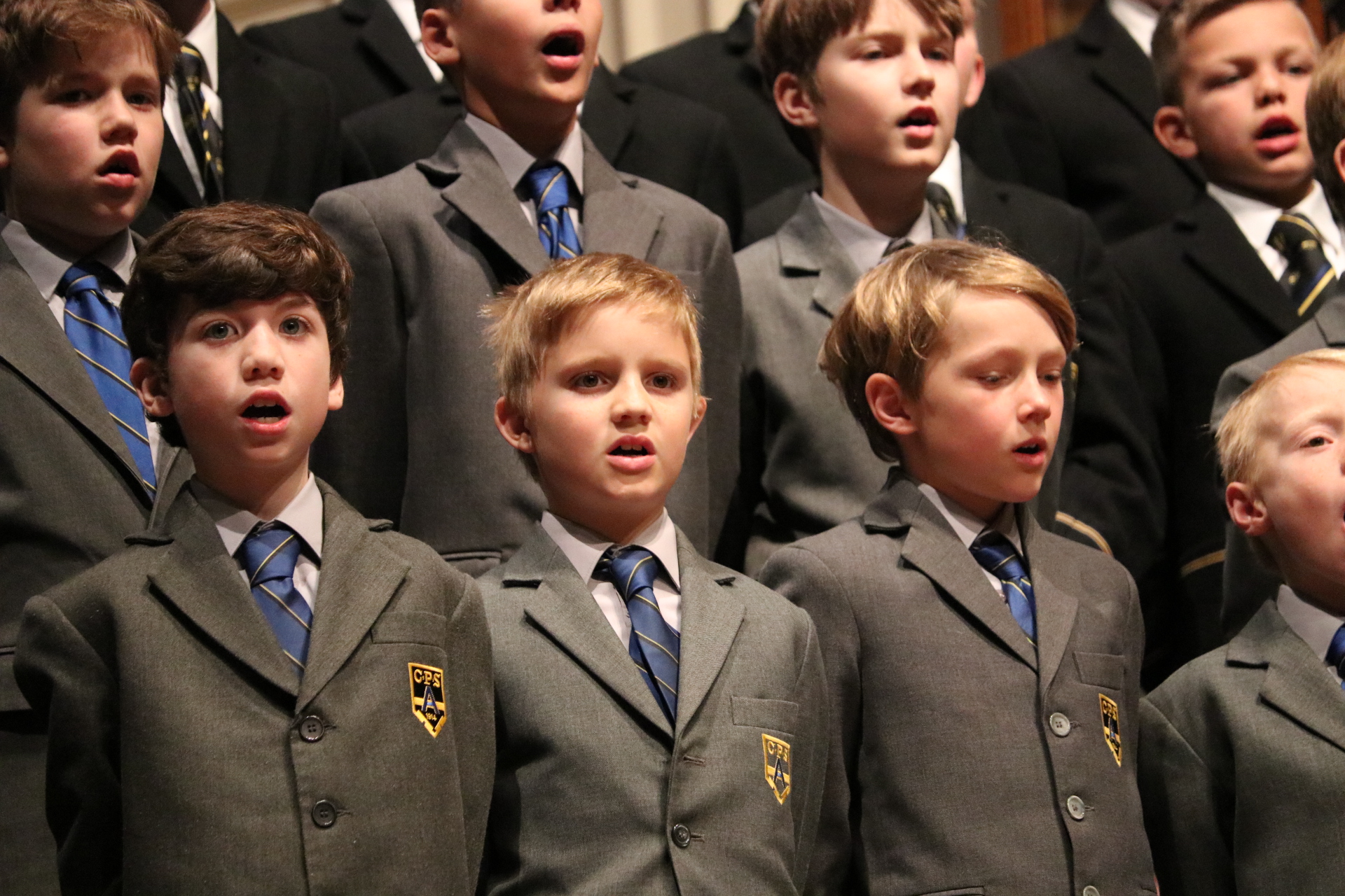 Coogee Prep boys singing together in school blazers