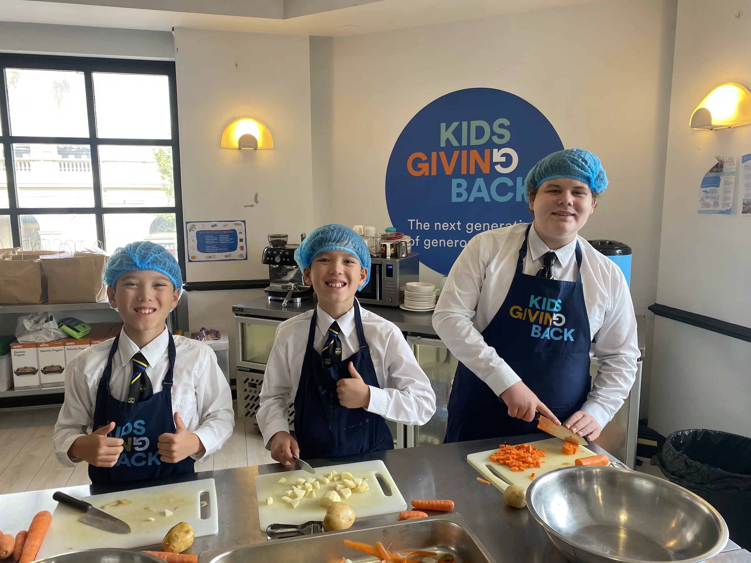 Coogee Prep boys preparing food together at a Kids Giving Back session