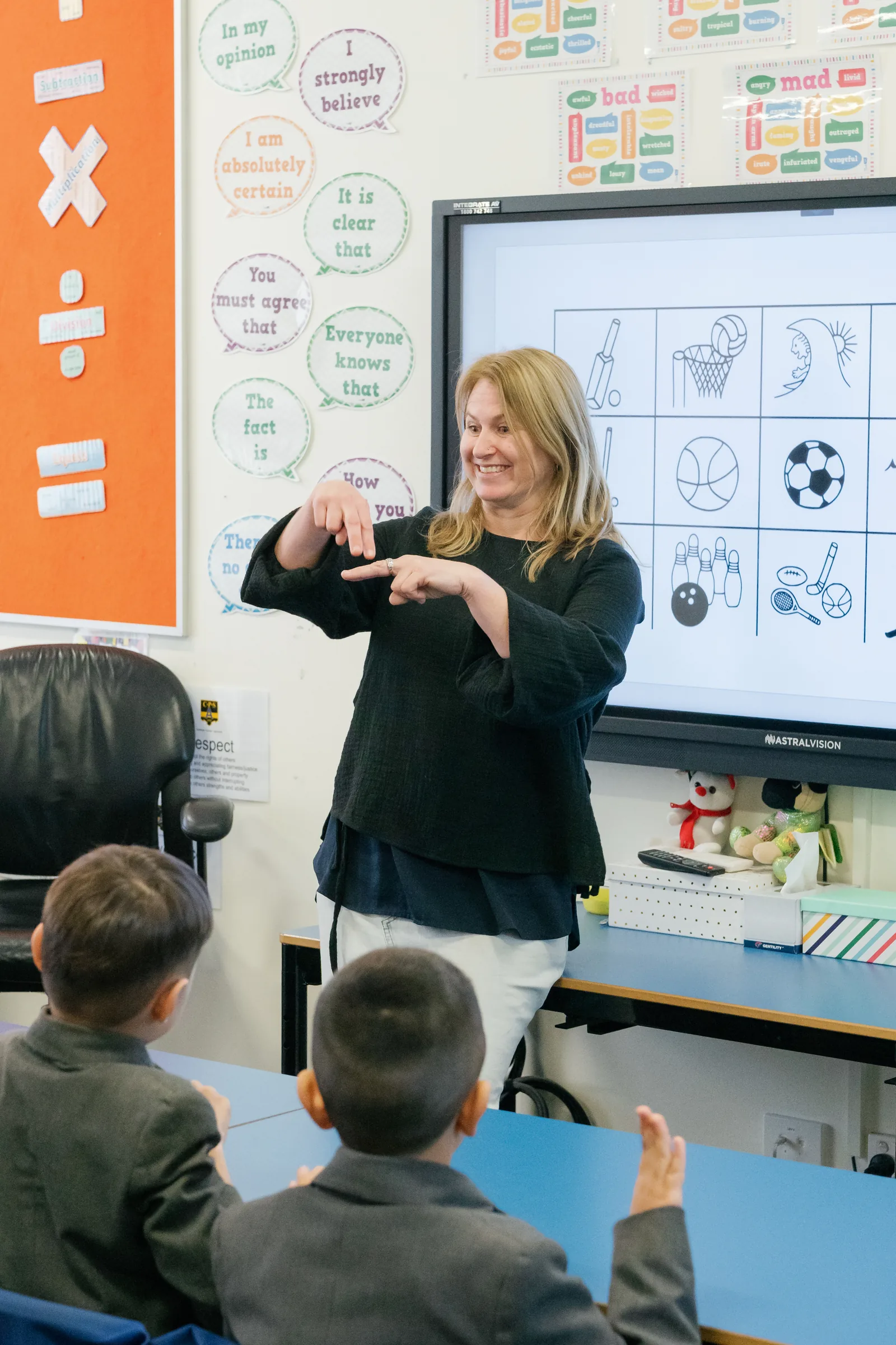 A teacher signing in Auslan to a class of Coogee Prep boys